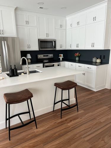 Dark backsplash with white kitchen island 